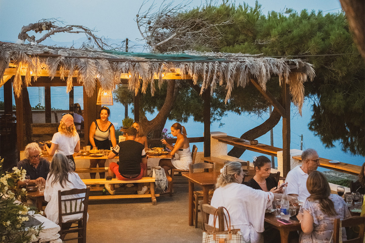 Stone taverna building in Apano Meria, northern Syros, with Aegean sea view