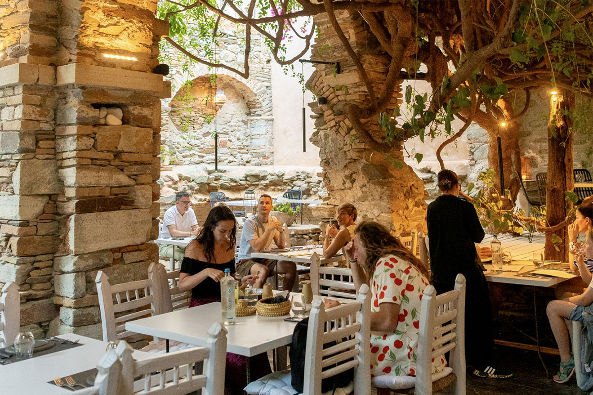 Green shaded courtyard restaurant in a historic building off Miaouli Square, Ermoupoli, Syros